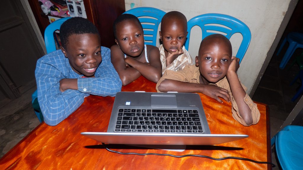 Children in the JMCM Office on laptop